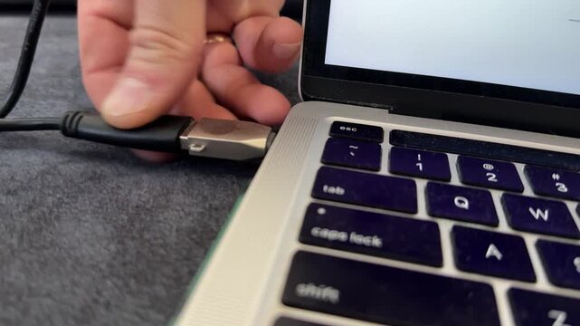 Hand plugging USB device into laptop port, computer connection and data transfer technology concept