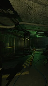 A hallway in a basement has heavy equipment along its sides. The area is dimly lit with green lights. Shadows stretch across the floor as cables run along the ground.
