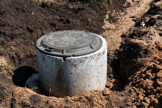 Construction Site Details. Municipal Construction Area Highlighting Safety And Standards Compliance. Site Of Urban Utility Upgrade Featuring Exposed Concrete And Groundwork Preparations