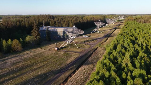 Aerial view of radio telescope array in forest clearing