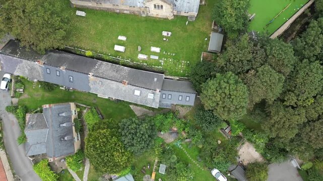 Vertical Top Down Aerial View of St Mary's Church Roof and Churchyard Burton Bradstock Dorset