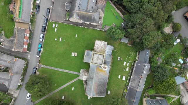Aerial Top Down View of St Mary's Church Pulling Back to Reveal Burton Bradstock Coast Dorset