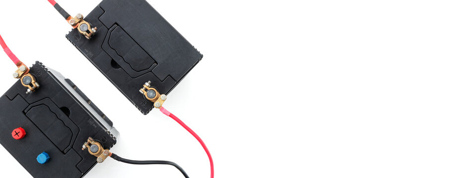 12 volt rechargeable batteries are connected in series with power cables for a 24 volt backup power system or UPS systems. Concept for renewable energy, emergency power supply, and energy storage, wit
