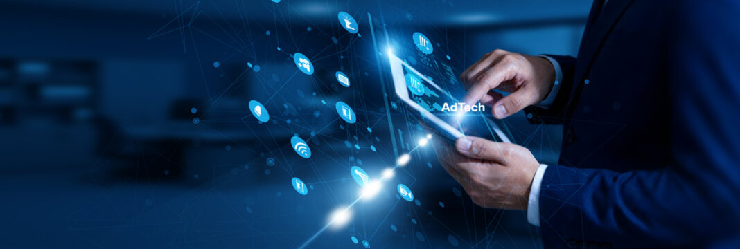 AdTech Specialist touching AdTech using tablet digital network, programmatic ads, targeting, analytics, campaign optimization.