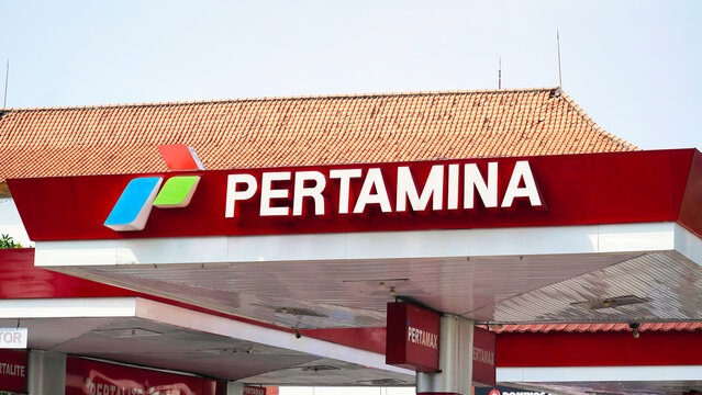 Pertamina gas station in Bali. Gasoline prices in 2024.Pertamina gas station logo displayed on a bright day in Indonesia, showing the brand's colors and design prominently in the sky