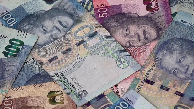 Various South African currency banknotes including 20, 50, and 100 ZAR denominations. Symbolizing South Africa's economy, business growth, financial success, and cash savings.