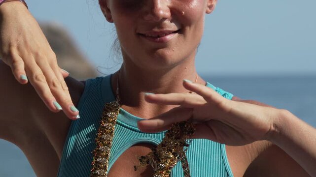 Woman dancing beach, joyful performance with traditional Indian jewelry