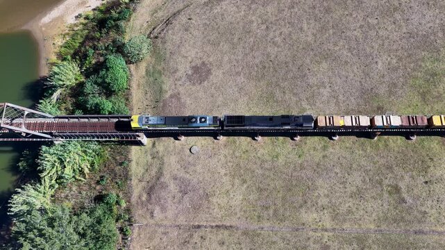 Aerial downward video of a freight train travelling through rural countryside in New South Wales Australia.