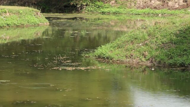 Ancient brick water gate and irrigation canal system in Sukhothai Historical Park, UNESCO World Heritage site, Thailand.