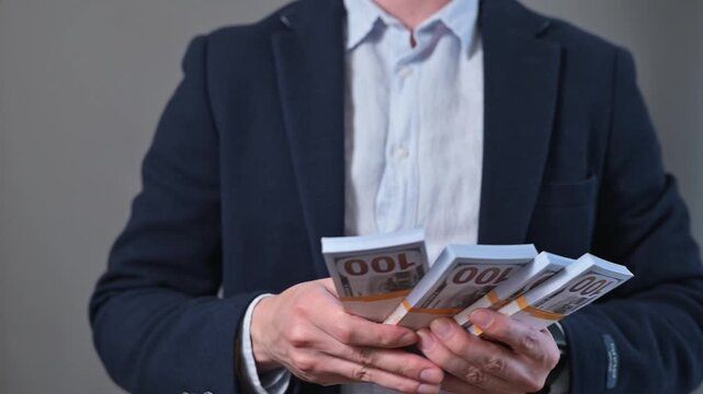 A man in formal attire interacts with cash, counting notes and checking his smartwatch. His actions suggest a focus on financial planning and time management in a professional environment