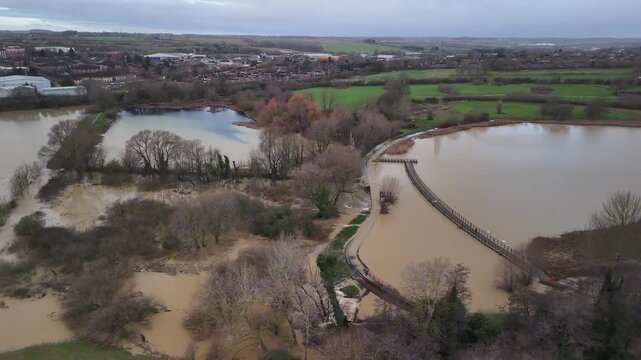 Aerial Drone View of Flooded Curved Lake and Walkway Bridge in Wicksteed Park Kettering Northamptonshire