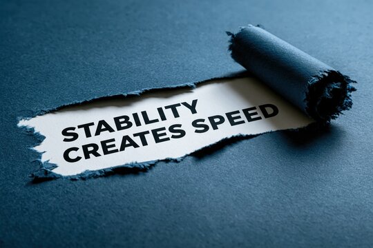 Paradoxical insight 'Stability Creates Speed' written on torn paper