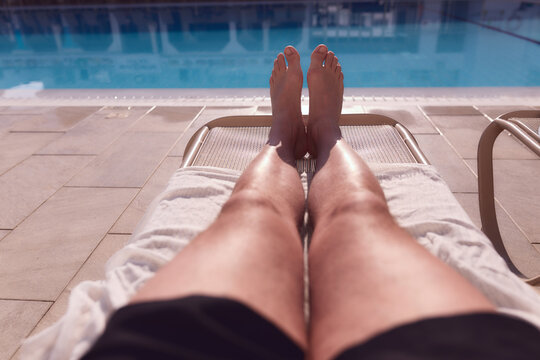 Man enjoying the hot summer at swimming-pool.