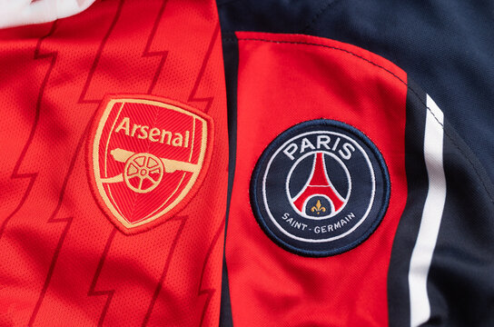 Ukraine, Kyiv - May 8, 2026. Close-up of Arsenal and Paris Saint-Germain football jerseys showcasing club crests and vibrant team colors.
