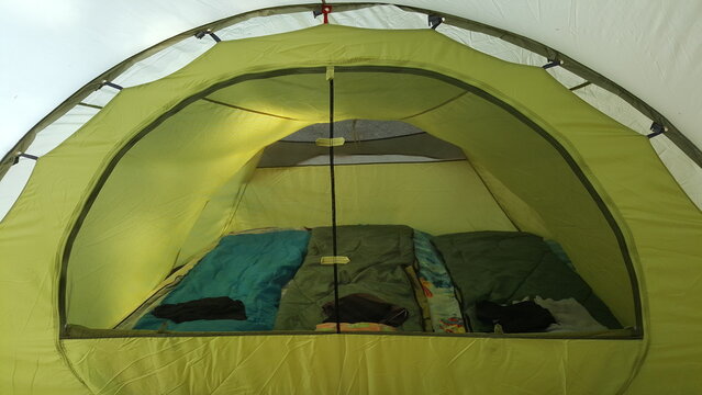 Interior view of large camping tent with travel equipment