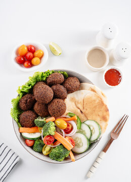 Arabic platter with falafel balls, salads, arabic bread and tahini