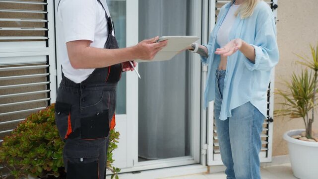 Woman refuses to sign for a package at doorstep while delivery courier waits with device. Delivery issue, service dispute, and customer decision concept in logistics.