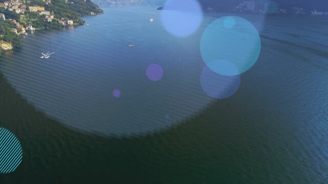 Boat leaving wake causing colored bokeh circles multiplying and drifting over lake for branding