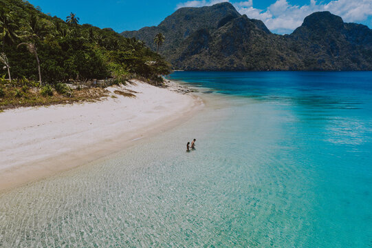Couple enjoying time  in front of the beach in Coron. Concept about summer, lifestyle,wanderlust travel and nature