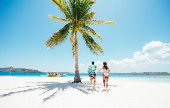 Couple spending time on a beutiful remote tropical island in the philippines. Concept about vacation and lifestyle.