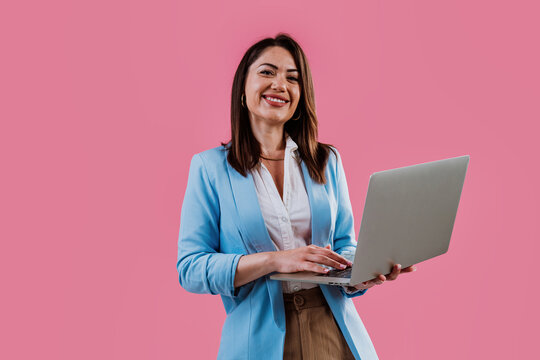 Young businesswoman smiling and holding a digital tablet