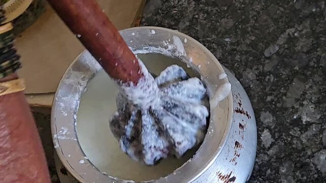 A traditional woman&rsquo;s bangles chime as her spinning hands whirl the Madhani. This rhythmic art churns curd into cool buttermilk, extracting fresh butter to be clarified into pure, golden ghee.