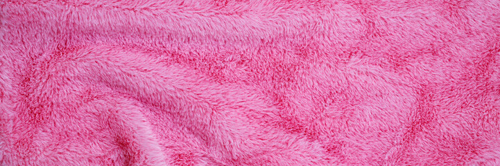 Soft pink blanket laid out on a surface to provide warmth and comfort during cool weather © Fleuronica