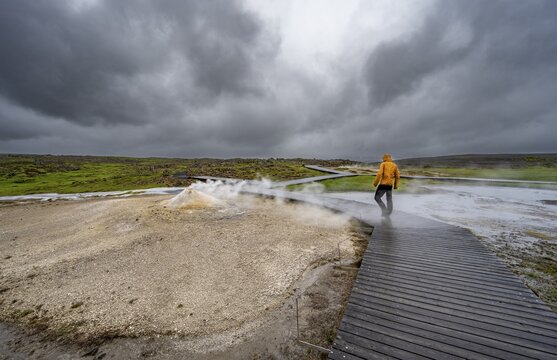 Tourist on a wooden path, steaming fumarole, Hveravellir geothermal area, Icelandic highlands, Su&eth;urland, Iceland