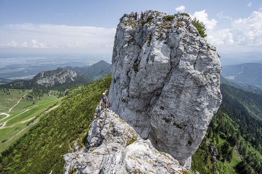 Climber with climbing rope on a climbing tour, climber on a mountain ridge, alpine climbing, crossing the Kampenwand, Chiemgau, Bavaria, Germany