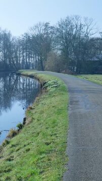 Empty footpath running along a tranquil riverbend