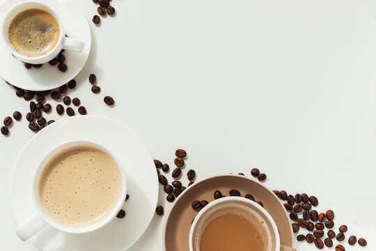 Coffee Cups with Beans in Circular Arrangement on White Background