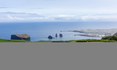 Obraz premium Mosteiros, San Miguel Island, Azores, Portugal. Green fields and farmland along the coast. Scenic view of the Atlantic Ocean and rock formations.