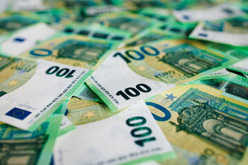 Obraz premium Close-up of crisp 100 euro banknotes arranged on a flat surface. Concept finance, savings and economy. 