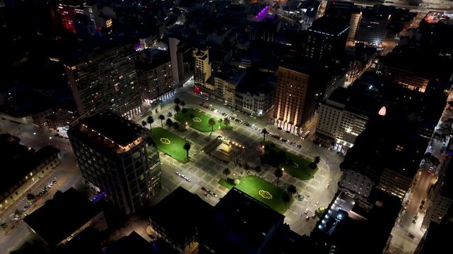 Independency Square In Montevideo Maldonado Uruguay. Aerial View Of Lush Green Park And Surrounding Buildings. Night Freeway Road Downtown Cityscape.