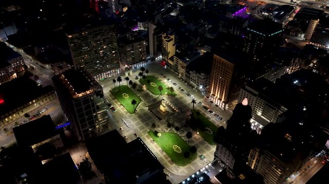 Night Independence Square In Montevideo Maldonado Uruguay. Aerial View Of A City Park Surrounded By Busy Streets And Buildings. Building Town Clouds Sky Illuminated Urban.