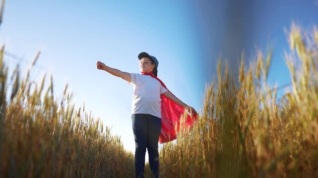 Superhero is a child who has had success playing a game of chess. Growth motivation family space concept. Superhero girl in a field of wheat. Superhero playing with a girl in a field of sunset wheat.