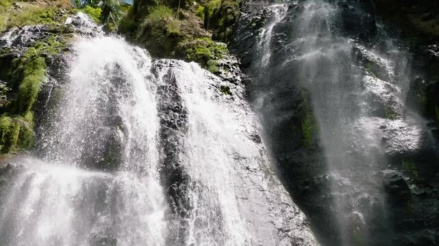Aerial view of tropical waterfall in the jungles. Slow motion. Balea Falls in the jungle. Negros, Philippines.