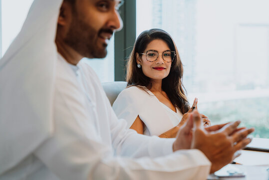 Arab business professionals discussing ideas in office meeting