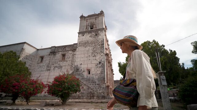 Mature woman enjoys her time visiting Mission Church in San Ignacio Baja California Mexico while taking in the local sights