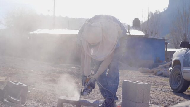 Close-up of a cutting machine splitting a construction brick of a house