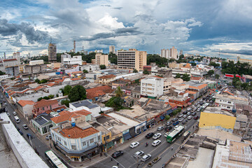 Obraz premium Aerial panoramic view of downtown Cuiabá, Mato Grosso, Brazil, showing urban buildings, active streets, mixed architecture and dramatic cloudy sky over the central metropolitan district
