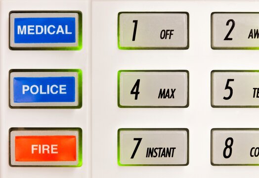 Closeup of buttons on alarm keypad with markings for numbers, medical, police, and fire.