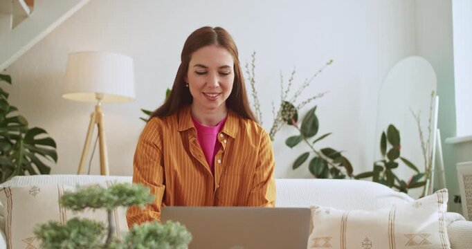 Young woman having an online video meeting at home