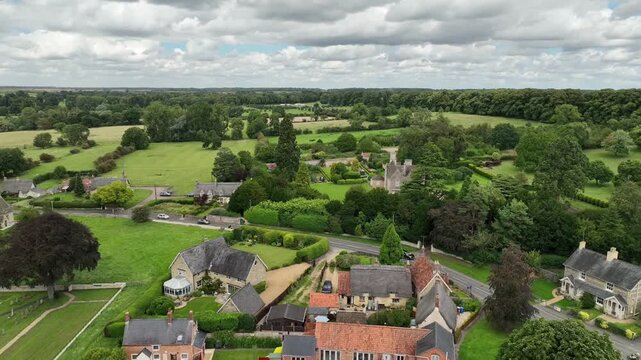 Aerial Wide View of Warkton Village with Church Tower Among Trees Northamptonshire England