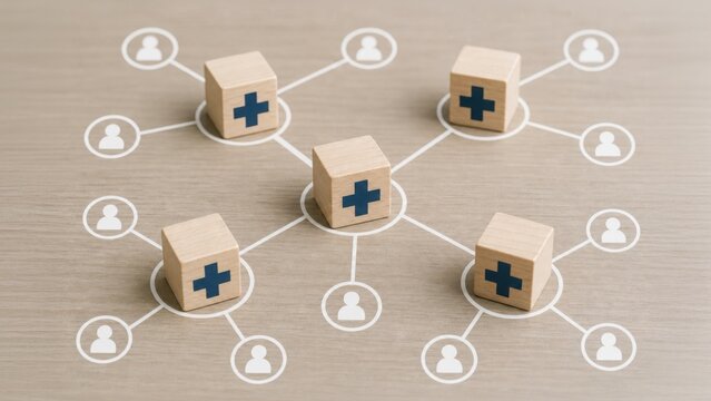 Wooden blocks with medical crosses form a network connecting to people icons, symbolizing a healthcare system, medical distribution, or health insurance network.