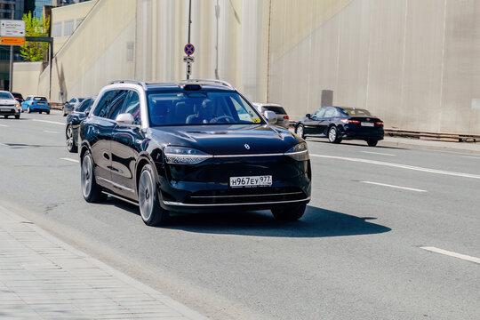 AITO M9 range extender electric car driving down the street
