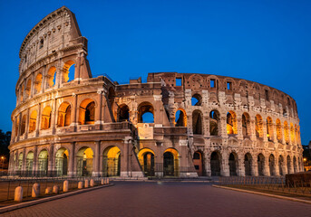 Naklejka premium Historic Roman Colosseum Illuminated at Blue Hour in Rome Italy