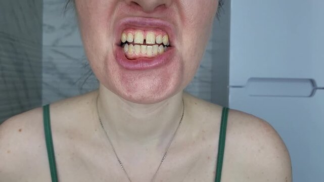 Woman applying white toothpaste to an orange toothbrush in a bathroom, dental care and oral hygiene routine amalgam filling