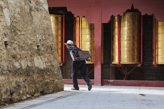 Tibetan Women Carrying inscribed Tablets to be Built into a Mani Wall
Tagong, Sichuan Province, Kham Tibet,