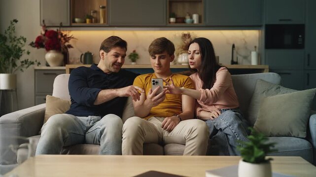 Parents and their teenage son using a smart home app on a phone, modern tech